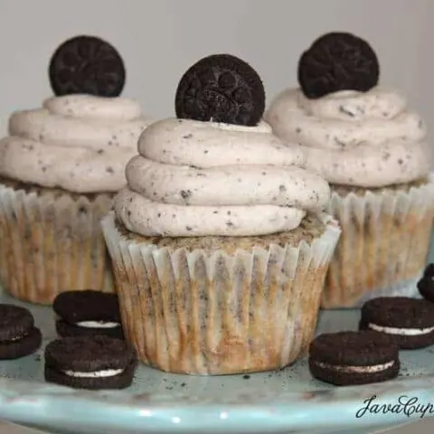 A trio of Oreo cupcakes with Oreo buttercream on a serving plate.