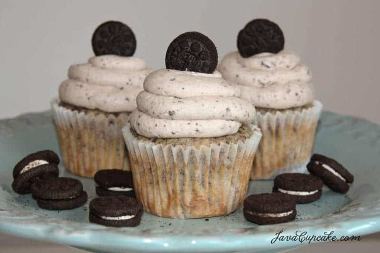 A trio of Oreo cupcakes with Oreo buttercream on a serving plate.