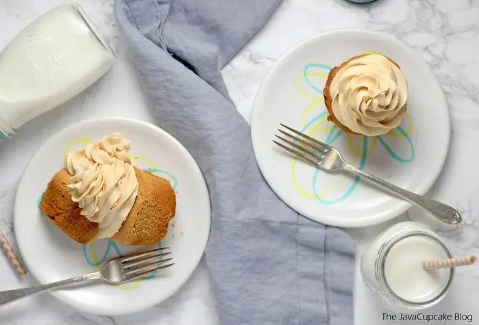 Peanut Butter Frosting on cupcakes served on white plates with a fork and a glass of milk