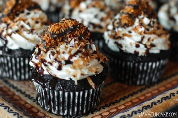 Easy Samoa Cupcakes - Chocolate cake topped with brown sugar frosting, toasted coconut, chocolate syrup and a Samoa cookie | JavaCupcake.com