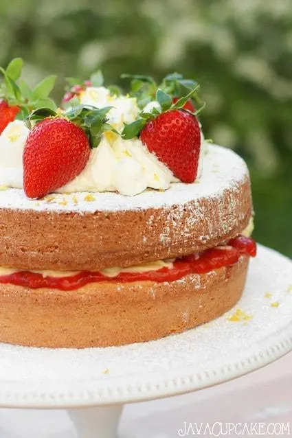 Victoria Sponge Sandwich Cake with vanilla pudding & fresh strawberry filling topped with fresh whipped cream, lemon zest and more strawberry! | JavaCupcake.com