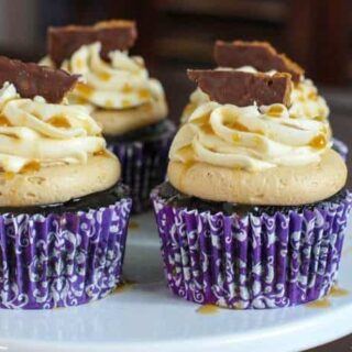 The Most Epic Cupcakes Ever! Guinness and Chocolate Cupcakes topped with Biscoff Buttercream, Bailey's Irish Cream Buttercream, Caramel Drizzle and a Chocolate dipped Bisocoff Cookie! | JavaCupcake.com