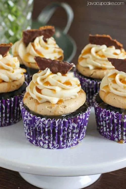 The Most Epic Cupcakes Ever!  Guinness and Chocolate Cupcakes topped with Biscoff Buttercream, Bailey's Irish Cream Buttercream, Caramel Drizzle and a Chocolate dipped Bisocoff Cookie! | JavaCupcake.com