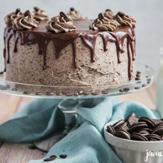 chocolate cake on a cake stand in a kitchen