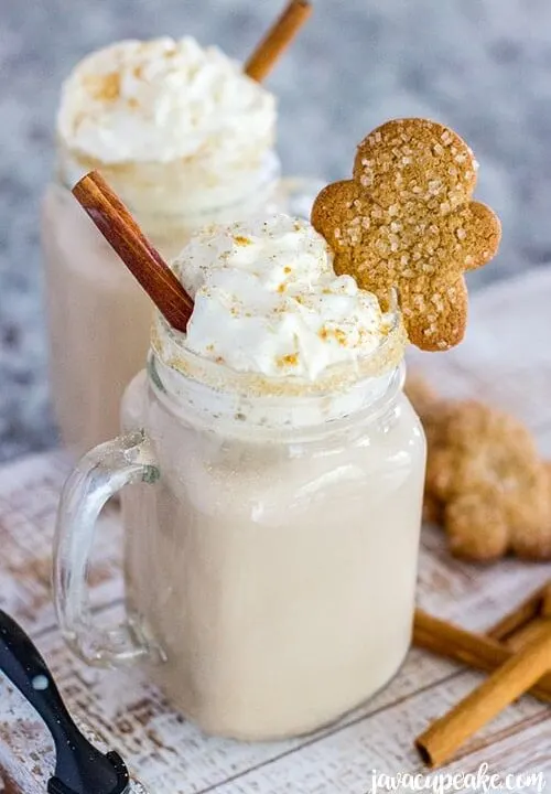 Spiced Gingerbread Coffee served with gingerbread cookies and cinnamon sticks.