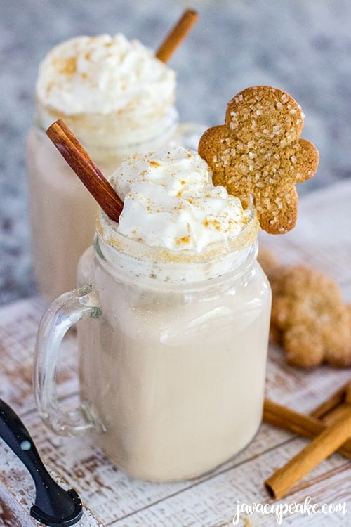 Spiced Gingerbread Coffee served with gingerbread cookies and cinnamon sticks.