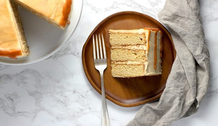 A slice of layer cake made from a caramel cake recipe