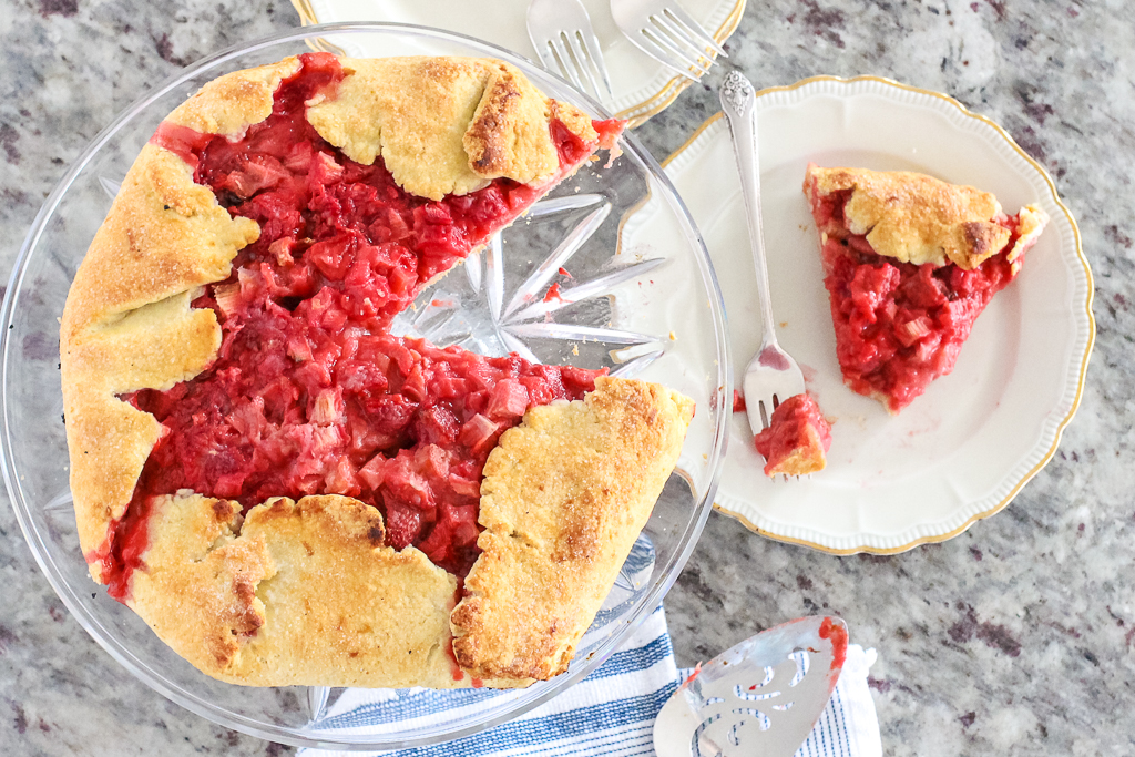bright red rhubarb and berry tart on a serving plate