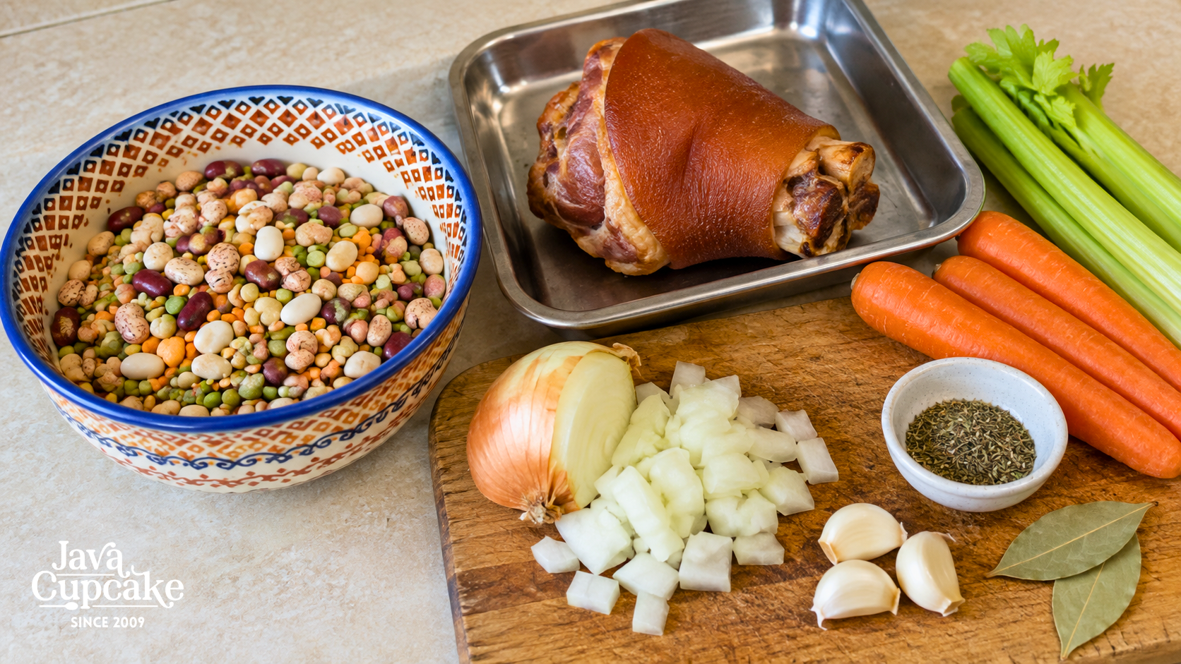 Mixed dried beans, smoked ham hock, carrots, celery, onion, garlic, and herbs for bean soup.